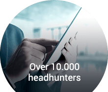 Professional using a tablet to connect with over 10,000 headhunters for senior-level career placements.