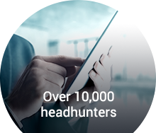 Professional using a tablet to connect with over 10,000 headhunters for senior-level career placements.