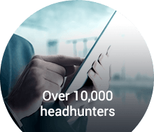 Professional using a tablet to connect with over 10,000 headhunters for senior-level career placements.